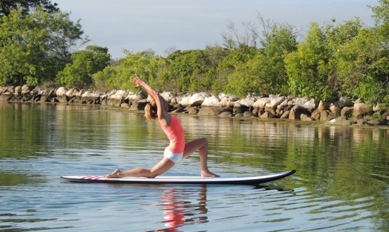 5 Reasons To Take Your Yoga Practice Off The Mat & Onto A Paddleboard Hero Image