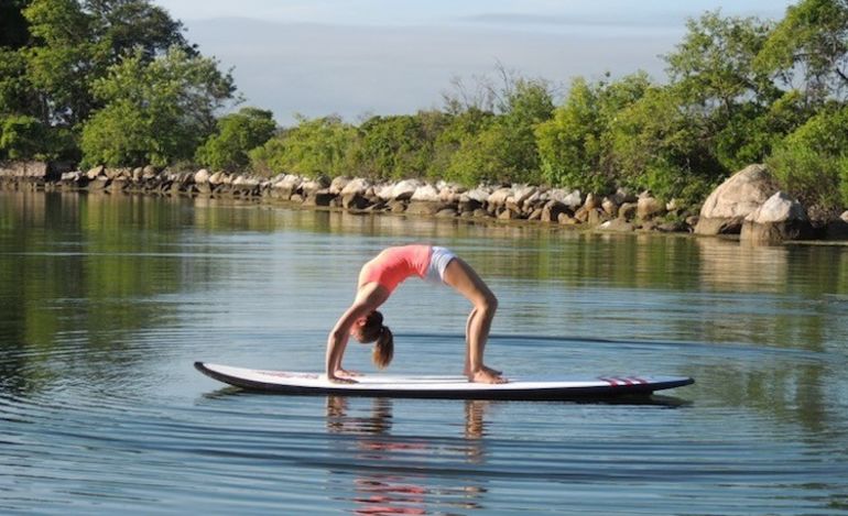 5 Reasons To Take Your Yoga Practice Off The Mat & Onto A Paddleboard Hero Image
