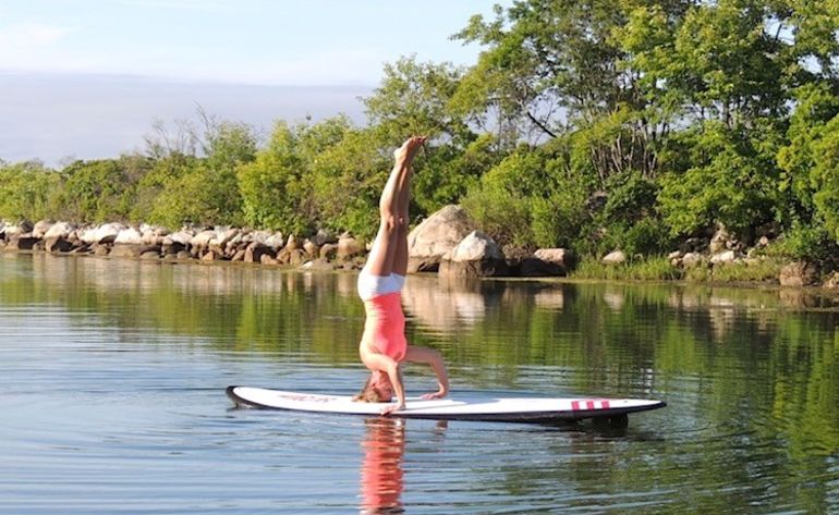 5 Reasons To Take Your Yoga Practice Off The Mat & Onto A Paddleboard Hero Image