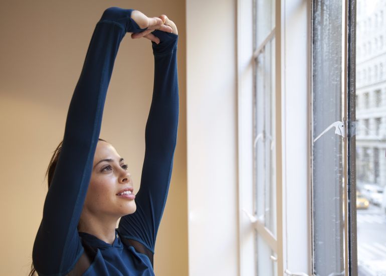 5 Stretches To Make A Long Flight (Or Day At Your Desk) Totally Pain-Free Hero Image