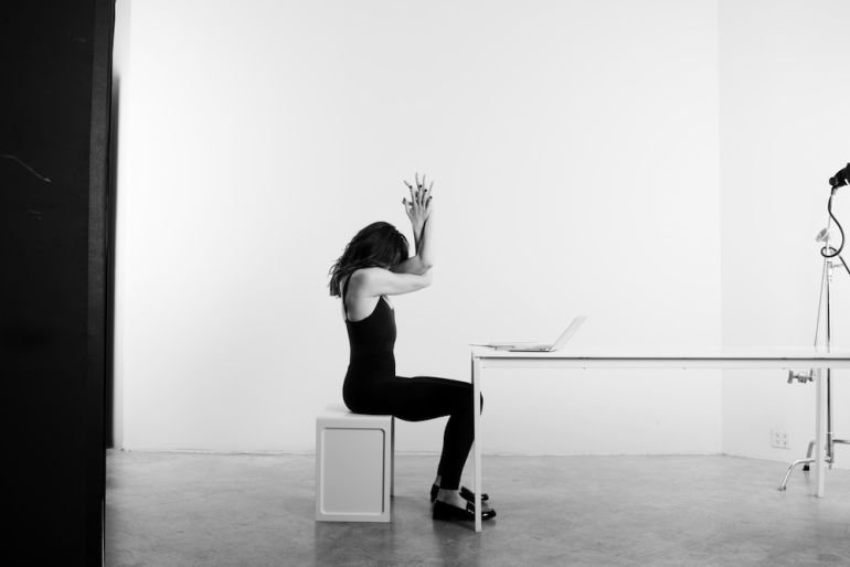 4 Easy Yoga Poses To Practice At Your Desk Hero Image