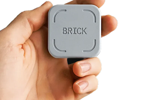 hand holding a brick phone device hand holding a brick phone device