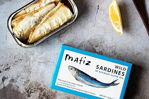 Matiz sardine can on marble table with leom Matiz sardine can on marble table with leom