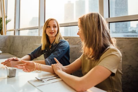 Image of two women talking.