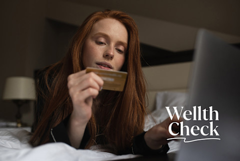 Woman looking at her credit card Woman looking at her credit card