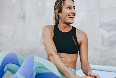 Woman Working Out Outside with Medicine Ball