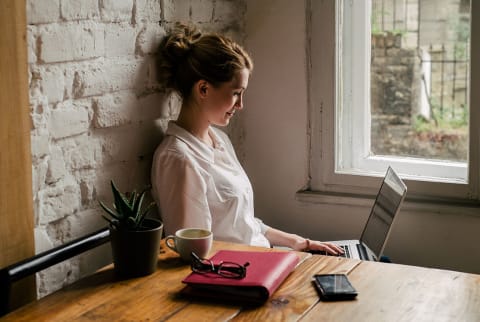 woman at a coffee shop on her laptop