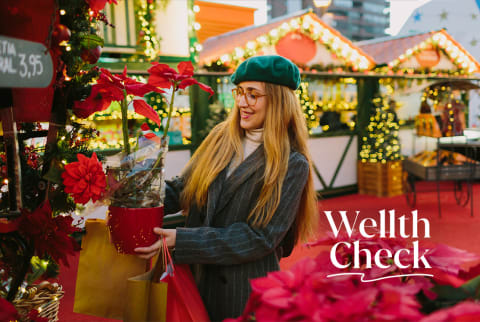 Woman in green beret holiday shopping for poinsettias