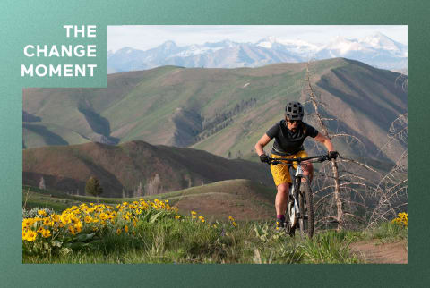 woman biking up mountain