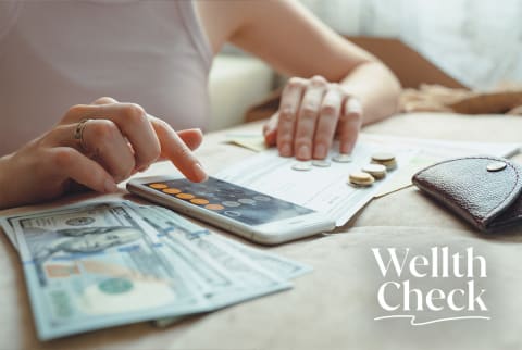 Woman budgeting with Wellth Check lockup
