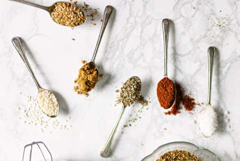 Herbs And Spices On Spoons On A Marble Background. Herbs And Spices On Spoons On A Marble Background.