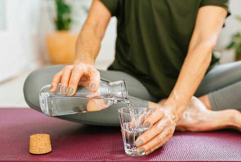 Woman pouring water into a glass