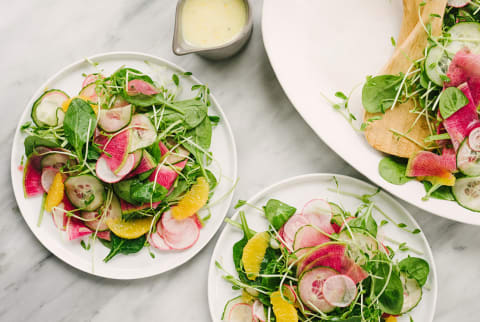 Overhead of Plant Based Meal with Spinach, Cucumbers, Radishes, Mandarin Oranges