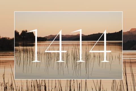 The numbers 1414 overlayed on an image of a body of water with mountains in the distance