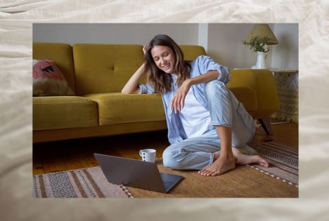 woman sitting on floor communicating online