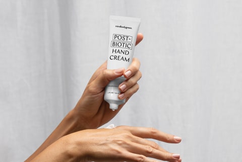mindbodygreen postbiotic hand cream applying on hand 