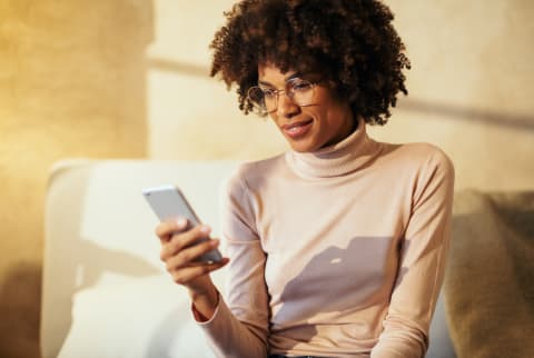 Woman Smiling at Her Phone