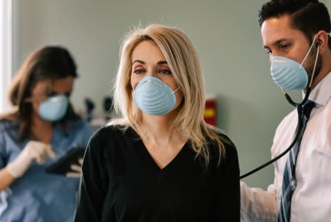 Woman At The Doctors Office With a Medical Mask On