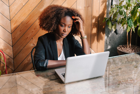 Business Woman Sitting At A Table With A Laptop, Working Business Woman Sitting At A Table With A Laptop, Working