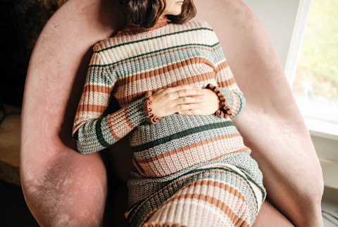 Pregnant Woman Lounging in a Pink Armchair Pregnant Woman Lounging in a Pink Armchair