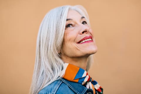 Portrait of a Woman in Her 60s Smiling and Looking Up