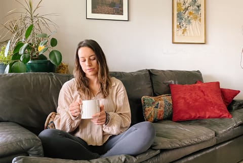 Sarah Regan Sitting in Her Living Room Enjoying a Cup of Tea