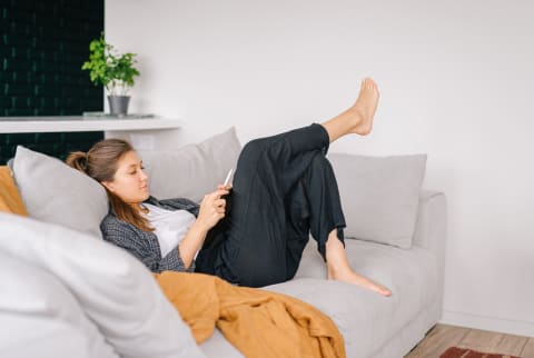 Young Woman Relaxing on the Couch at Home Alone