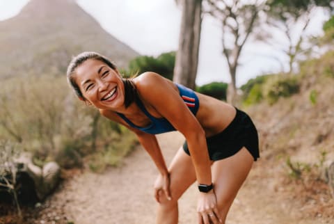 Woman Running Outdoors, Catching Her Breath