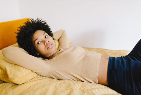 Anxious Woman Reclined On Her Bed