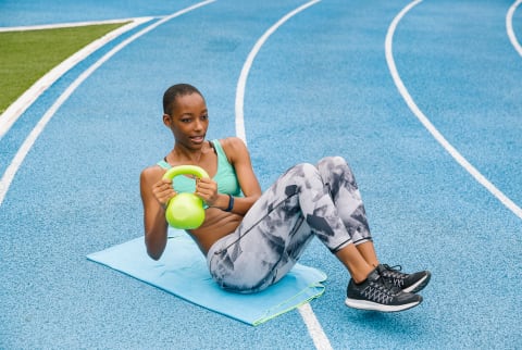 Woman Working Out With A Kettle Bell