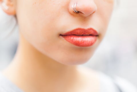 woman with a red lip and nose ring