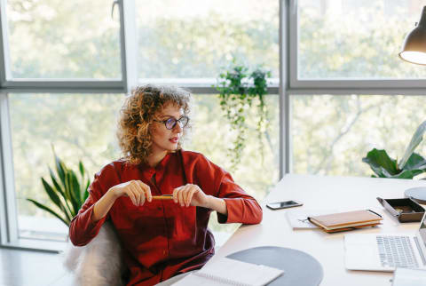 Thoughtful Woman at Her Desk