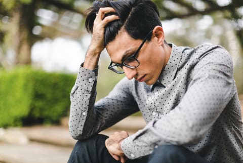 Pensive Businessman Sitting Outdoor