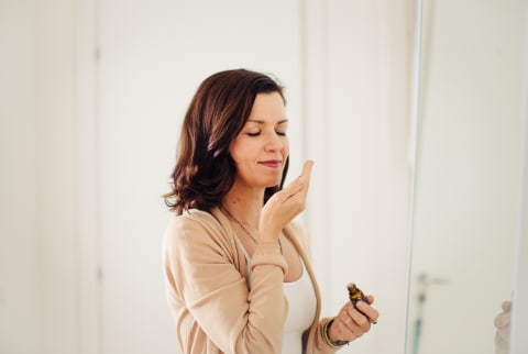 Woman Smelling an Aromatic Essential Oil
