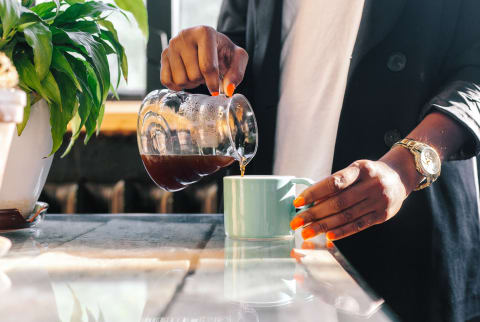 Unrecognizable Woman Pouring Coffee Into Mug