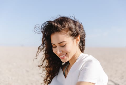 Smiling Brunette Woman Outside on a Breezy Day