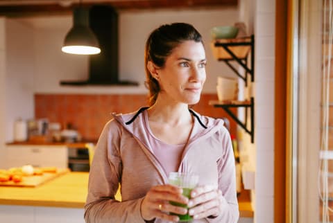 Woman Drinking A Smoothie At Home.