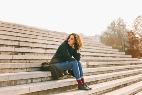 Thoughtful Young Woman Sitting On The Stairs