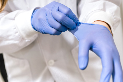Medical Professional Removing Protective Gloves Medical Professional Removing Protective Gloves