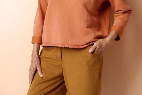 Close-up view of unrecognizable senior woman in elegant casual clothes, her hand in pocket