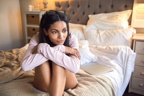 Woman Daydreaming On Her Bed