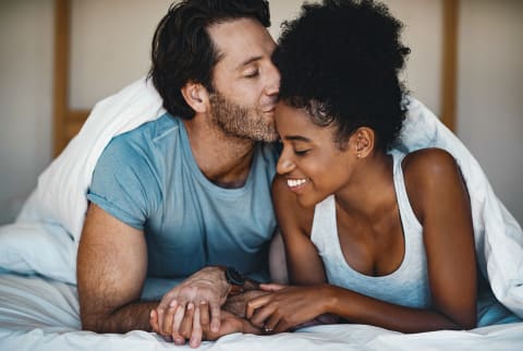 Couple Cuddling In Bed