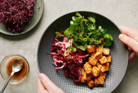 Baked tofu with sesame, sriracha and a micro herb salad and a peanut and chili dressing.