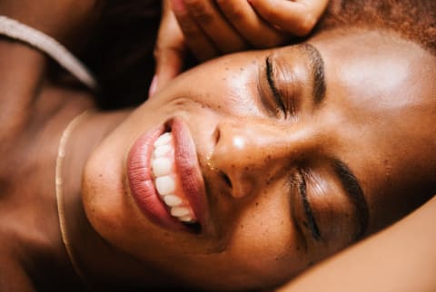 Close up portrait of beautiful woman smiling with her eyes closed