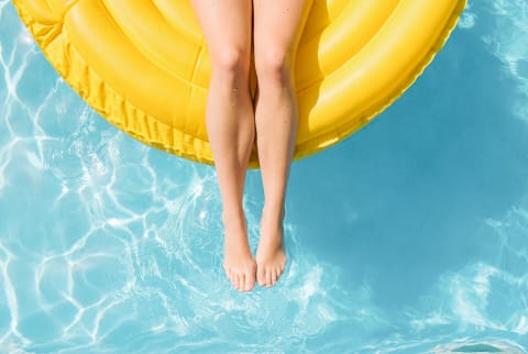 Woman Floating On Inflatable Tube In Summer