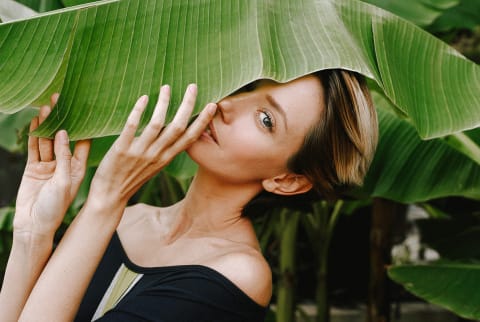 Woman in Her 30s Holding a Banana Leaf