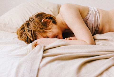 Happy and Satisfied Woman in Bed