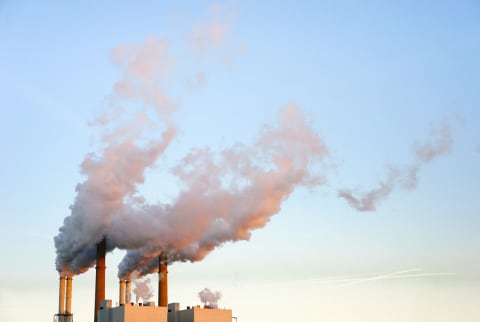 (Last Used: 1/15/21) Industrial chimneys with smoke, at sunset