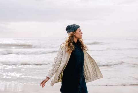 Woman on the Beach in Wintertime Soaking in the Moment