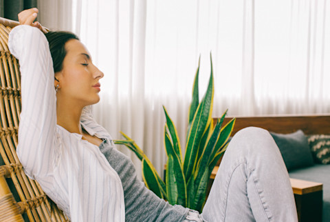 Woman Reclining in a Chair at Home in the Afternoon Woman Reclining in a Chair at Home in the Afternoon